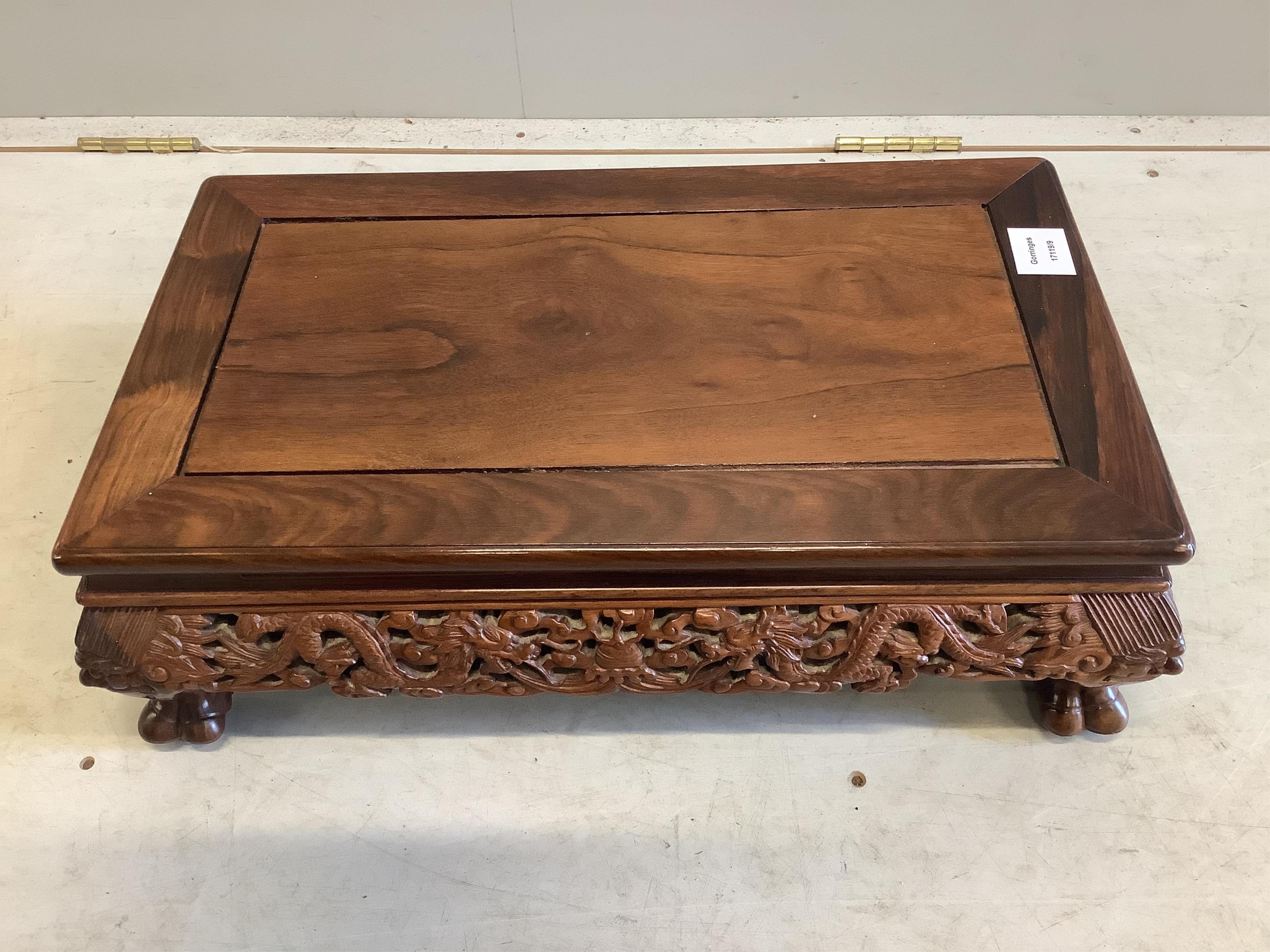 A Chinese rectangular rosewood stand or low table, width 56cm, depth 33cm, height 18cm. Condition - good